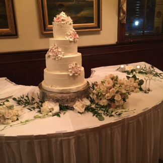 Bridal bouquet placed by cake