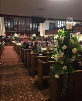 Flowers and candles on aisle
